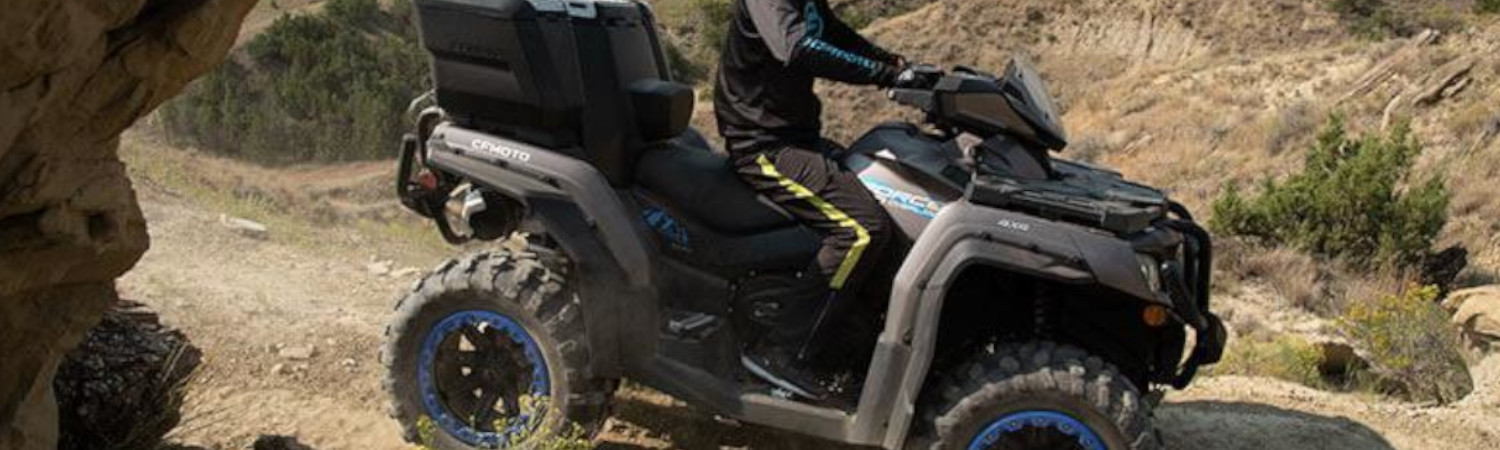 Man riding on a 2021 CFMoto CForce 1000 out in the desert